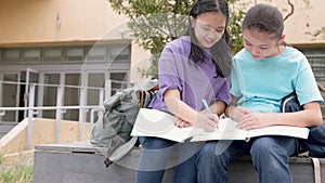 Happy Asian student girls study and discuss homework in school