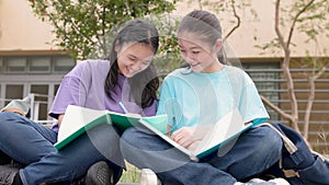 Happy Asian student girls study and discuss homework in school