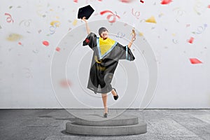 Happy asian student woman celebrate her graduation with confetti