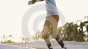 Happy Asian teen boy exercise surf skate at parking in her house