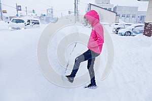 Happy asian teenager in bright pink jacket enjoying herself play