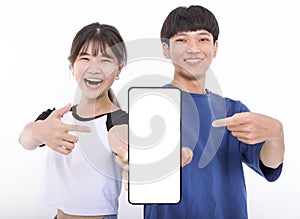 Happy Asian teenager students holding smartphone mockup of blank screen