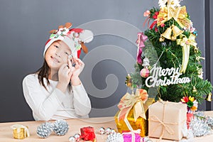 Happy asian thai child girl with Christmas gifts near a Christm