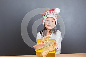 Happy asian thai child girl with Christmas gifts near a Christm