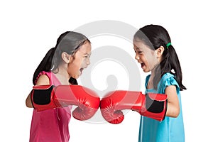 Happy Asian twins girls with boxing gloves