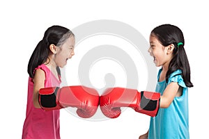 Happy Asian twins girls with boxing gloves