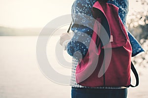 Happy Asian woman backpacker relaxing on holiday