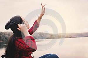 Happy Asian woman backpacker relaxing on holiday travel concept