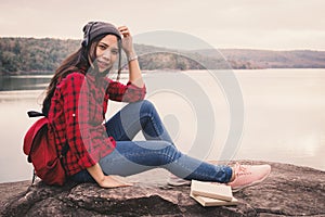 Happy Asian woman backpacker relaxing on holiday travel concept