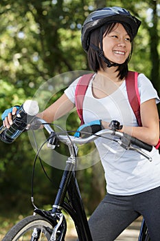 happy asian woman with bicycle