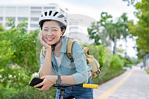 Happy Asian woman with bicycle and background in the garden copy space