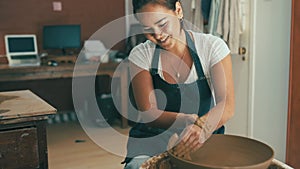 Happy asian woman, clay and pottery with bowl for craft, art or ceramics of creative at the workshop. Female person