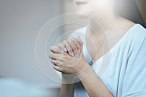 Happy asian woman with hand in praying position,Female prayer hands clasped together