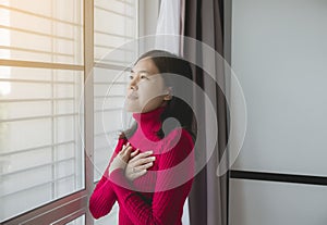 Happy asian woman with hand in praying position,Female prayer hands clasped together