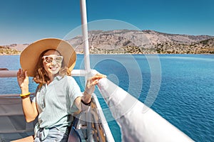 Asian woman in hat enjoying travel and vacation on Cruise ship. Tourist girl on the deck