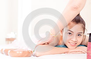 Happy Asian woman having massage in Spa