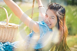 Happy Asian woman having relax time on a swing in nature field for nature hapiness lifestyle