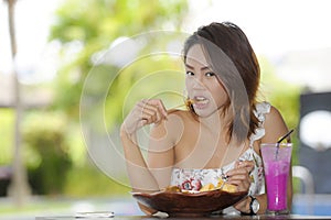 Happy Asian woman on her 20s enjoying healthy food for brunch breakfast or lunch sitting at coffee shop