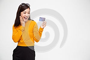 Happy Asian woman holding credit card or cash advances.