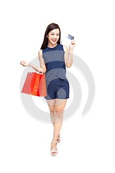 Happy Asian woman holding credit card or cash advances and shopping bag.