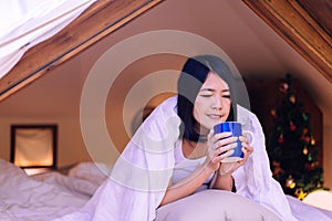 Happy asian woman holding and drinking hot coffee in the morning,Enjoys of resting time,Close up