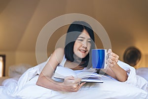 Happy asian woman holding and drinking hot coffee in the morning,Enjoys of resting time,Close up