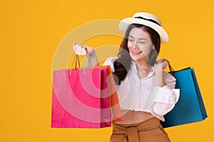 Happy asian woman holding shoppingbag with mid year sale photo