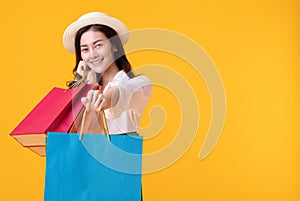 Happy asian woman holding shoppingbag with mid year sale photo