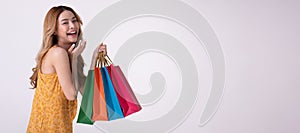 Happy asian woman holding shoppingbag with mid year sale