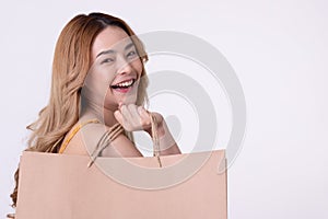 Happy asian woman holding shoppingbag with mid year sale photo