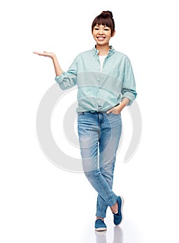 happy asian woman holding something on her hand