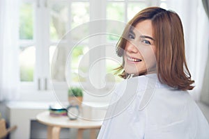 Happy asian woman at home.