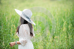 Happy asian woman lifestyle in the meadow yellow flower sunrise. Active Outdoor Relax and enjoy