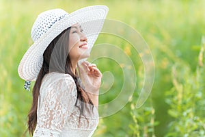 Happy asian woman lifestyle in the meadow yellow flower sunrise. Active Outdoor Relax and enjoy in Nature.