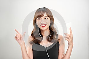 Happy asian Woman listening to music on headphones. Young fresh Asian female model