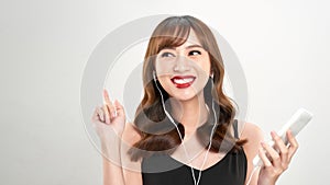 Happy asian Woman listening to music on headphones. Young fresh Asian female model