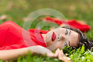 Happy Asian Woman Lying Down on Grassland