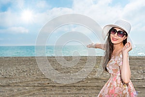 Happy asian woman making gestures of presentation