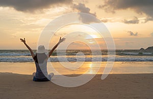 Happy Asian woman relaxing and enjoying at the beach during travel holidays vacation outdoors at ocean or nature sea at sunset