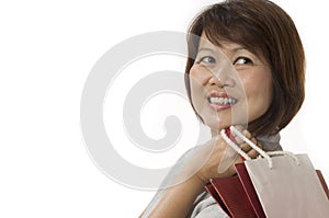 Happy Asian woman with shopping bags