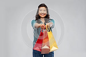 Happy asian woman with shopping bags