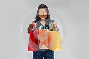 Happy asian woman with shopping bags