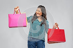 Happy asian woman with shopping bags