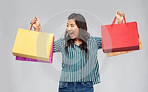 Happy asian woman with shopping bags