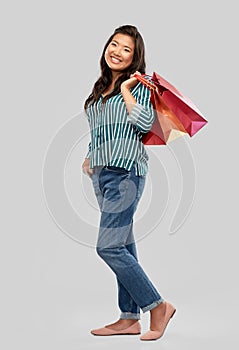 Happy asian woman with shopping bags