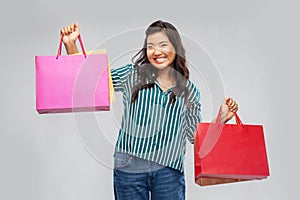 Happy asian woman with shopping bags