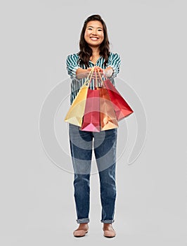 Happy asian woman with shopping bags