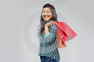 Happy asian woman with shopping bags