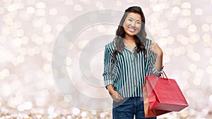 Happy asian woman with shopping bags