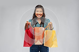 Happy asian woman with shopping bags